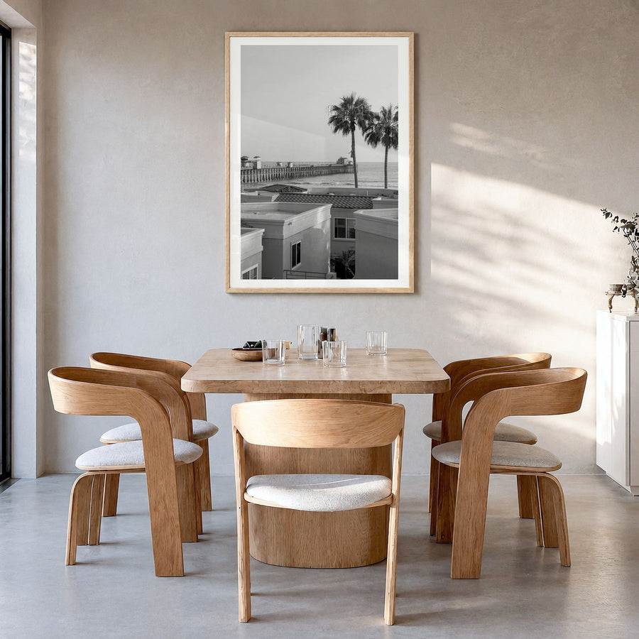 Oceanside Photo No 1 Poster in a natural wood frame, hanging in a dining room, white border