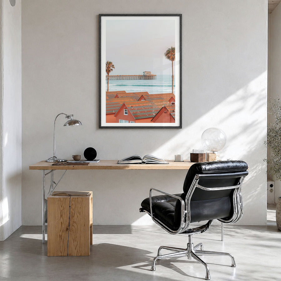 Oceanside Photo No 3 Poster in a black wood frame, hanging in a bright home office, white border