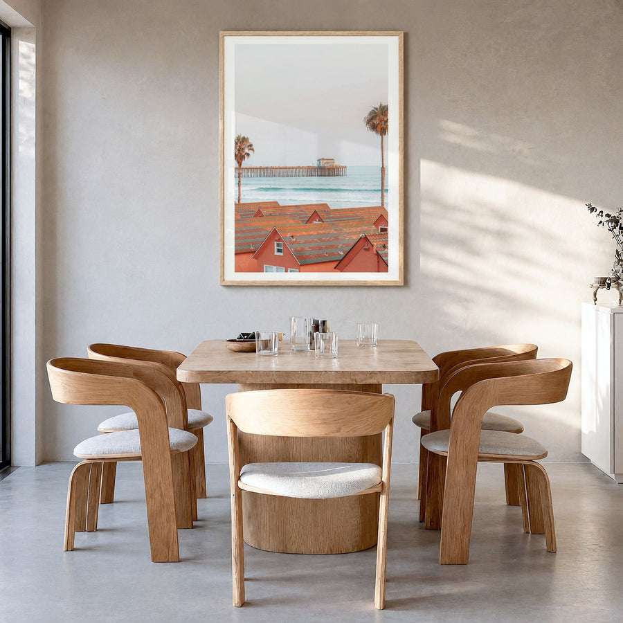 Oceanside Photo No 3 Poster in a natural wood frame, hanging in a dining room, white border