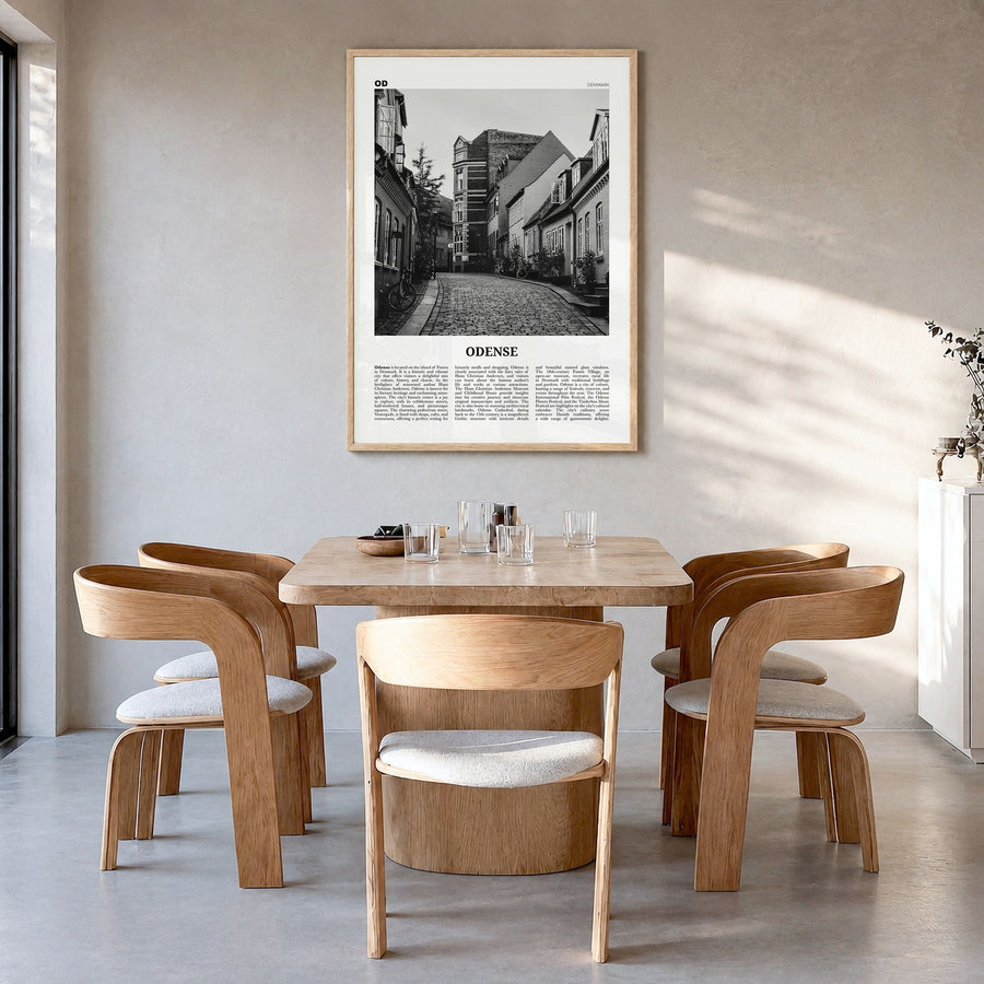 Odense Newspaper Poster in a natural wood frame, hanging in a dining room