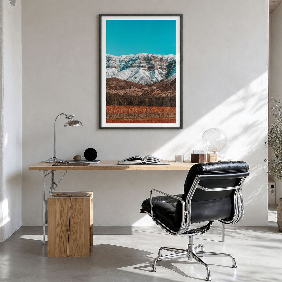 Ojai Photo Poster in a black wood frame, hanging in a bright home office, white border