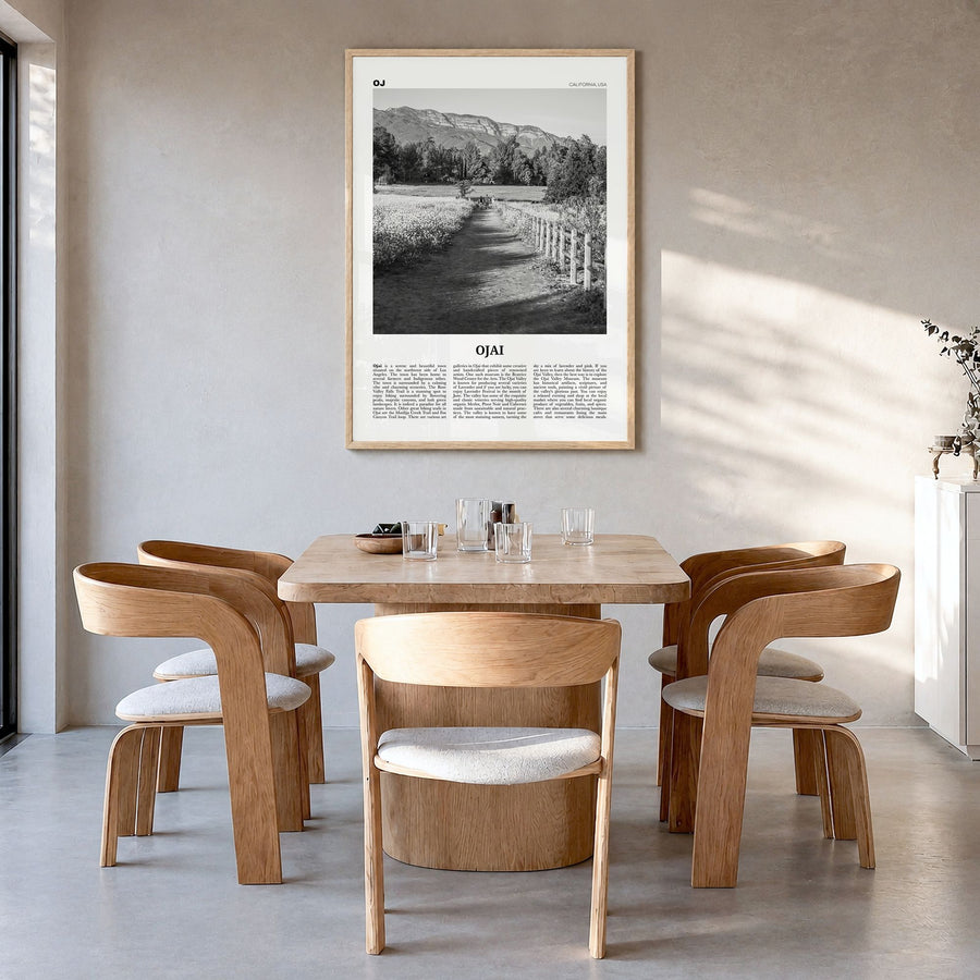 Ojai Newspaper Poster in a natural wood frame, hanging in a dining room