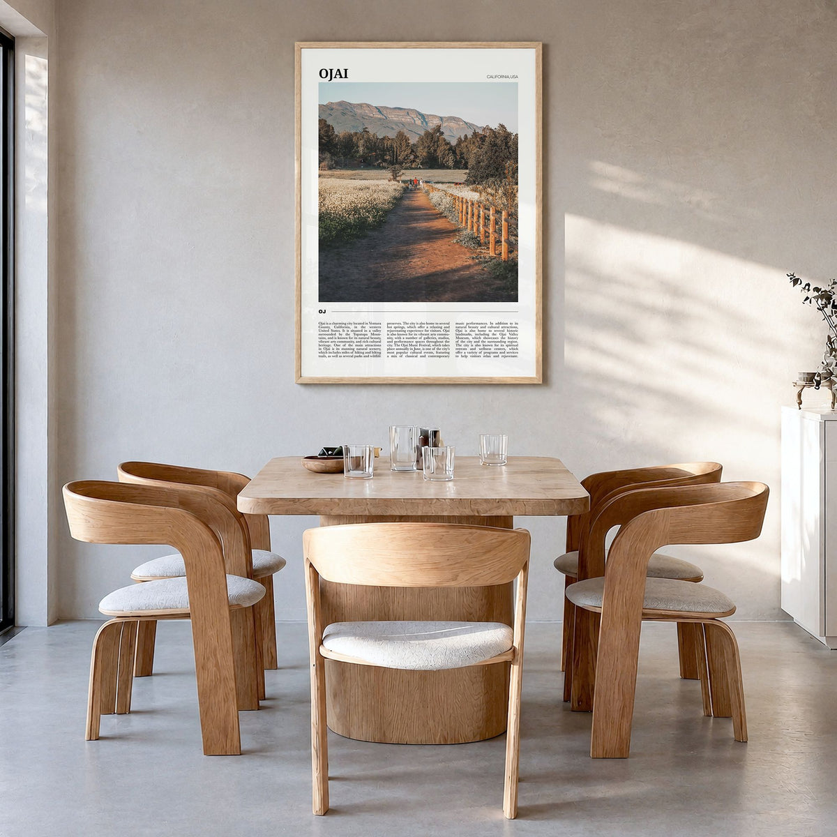 Ojai Travel Poster in a natural wood frame, hanging in a dining room