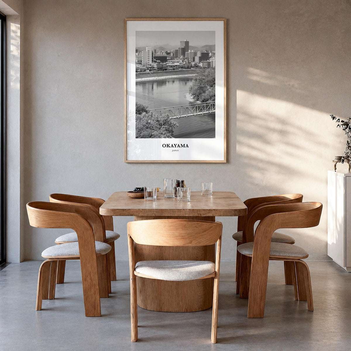 Okayama black & white classic poster of Japan – vertical wall art in natural wood frame, hanging on wall