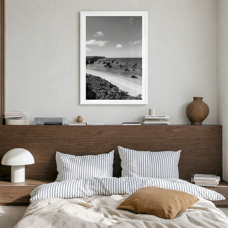 Okinawa Photo Poster in a white wood frame, hanging in a bedroom, white border
