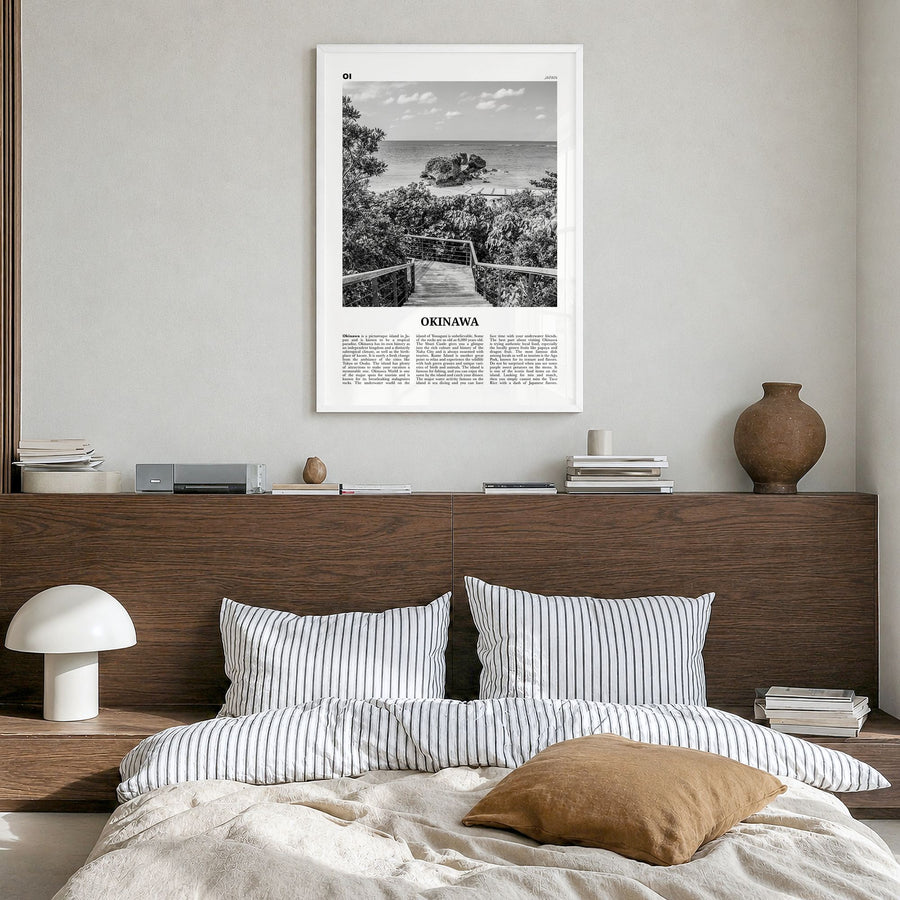 Okinawa Newspaper Poster in a white wood frame, hanging in a bedroom