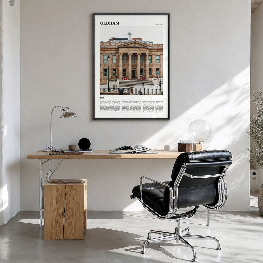 Oldham Travel Poster in a black wood frame, hanging in a bright home office