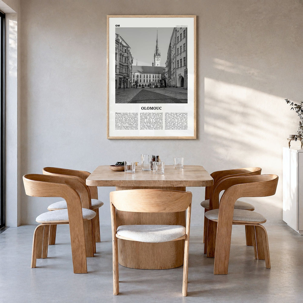 Olomouc Newspaper Poster in a natural wood frame, hanging in a dining room