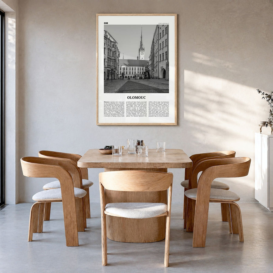 Olomouc Newspaper Poster in a natural wood frame, hanging in a dining room