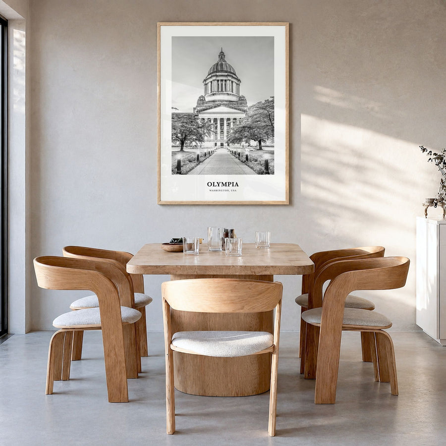 Olympia Classic No 1 Poster in a natural wood frame, hanging in a dining room