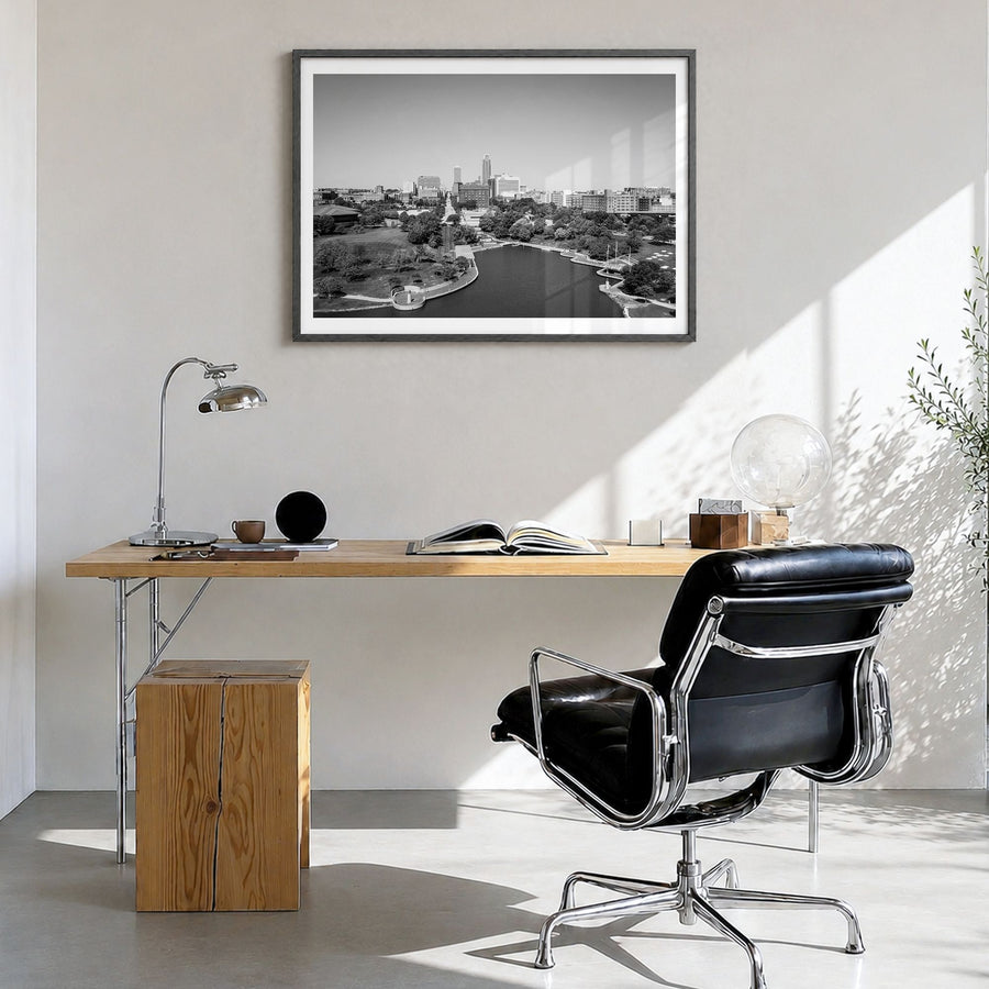 Omaha Photo Poster in a black wood frame, hanging in a bright home office, white border