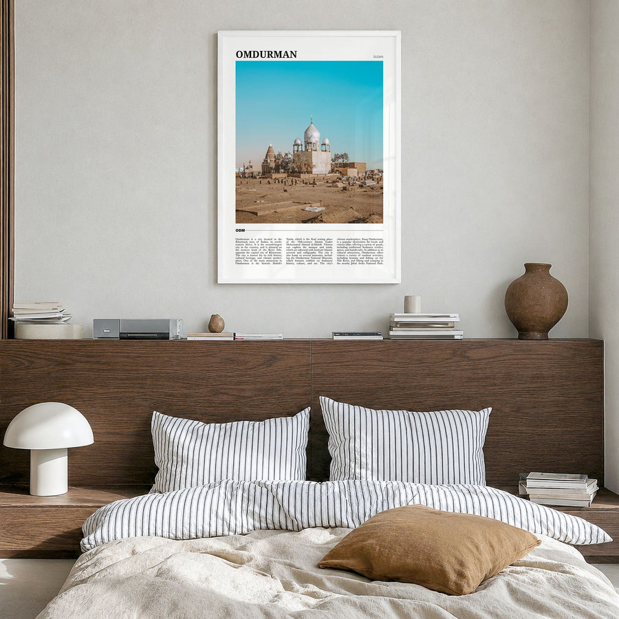 Omdurman Travel Poster in a white wood frame, hanging in a bedroom