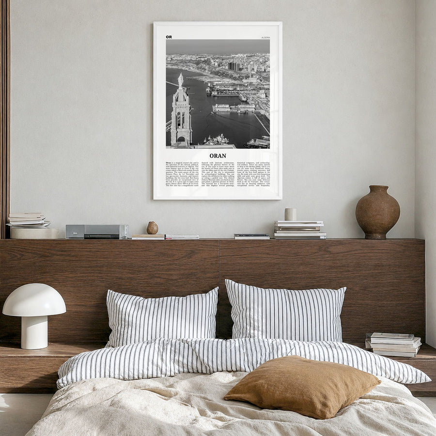 Oran Newspaper Poster in a white wood frame, hanging in a bedroom