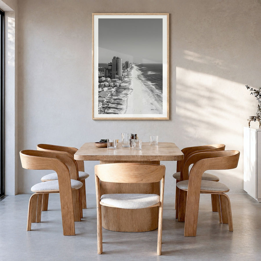 Orange Beach Photo Poster in a natural wood frame, hanging in a dining room, white border