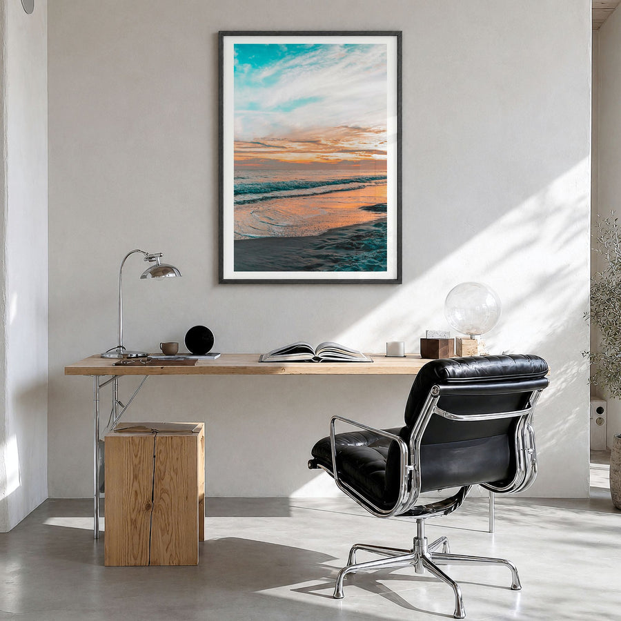 Orange Beach Photo Poster in a black wood frame, hanging in a bright home office, white border