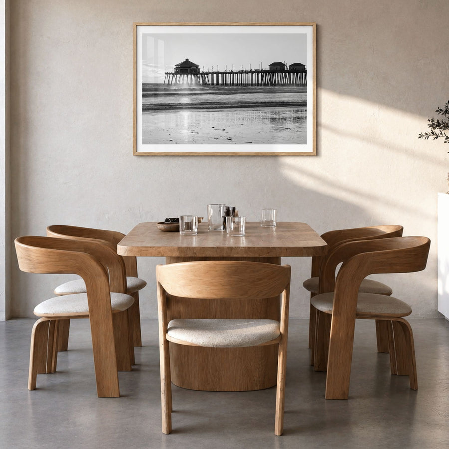Orange County Photo Poster in a natural wood frame, hanging in a dining room, white border