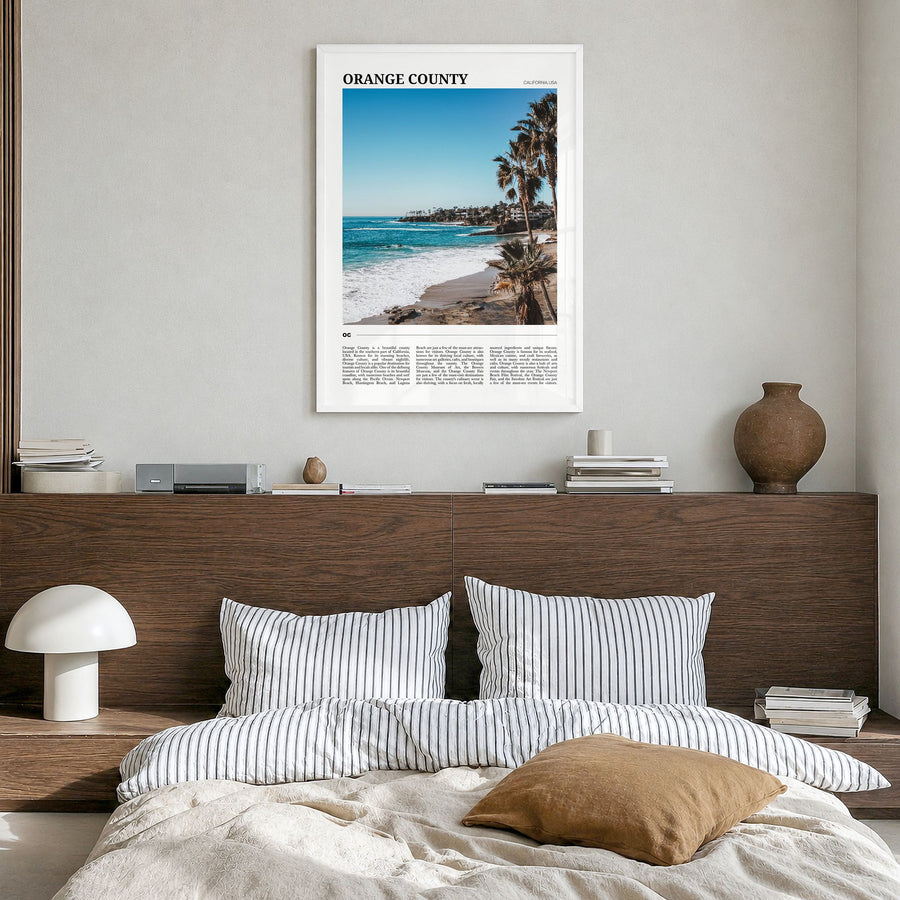 Orange County Travel Poster in a white wood frame, hanging in a bedroom