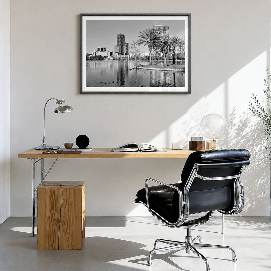Orlando Photo Poster in a black wood frame, hanging in a bright home office, white border