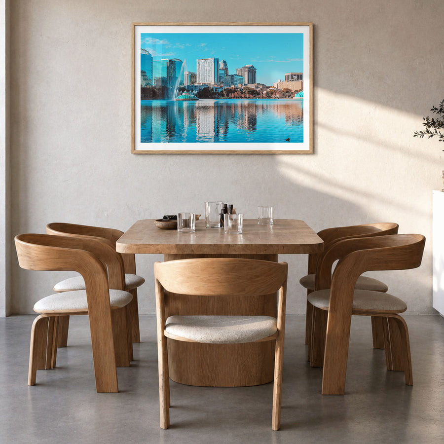 Orlando Photo Poster in a natural wood frame, hanging in a dining room, white border