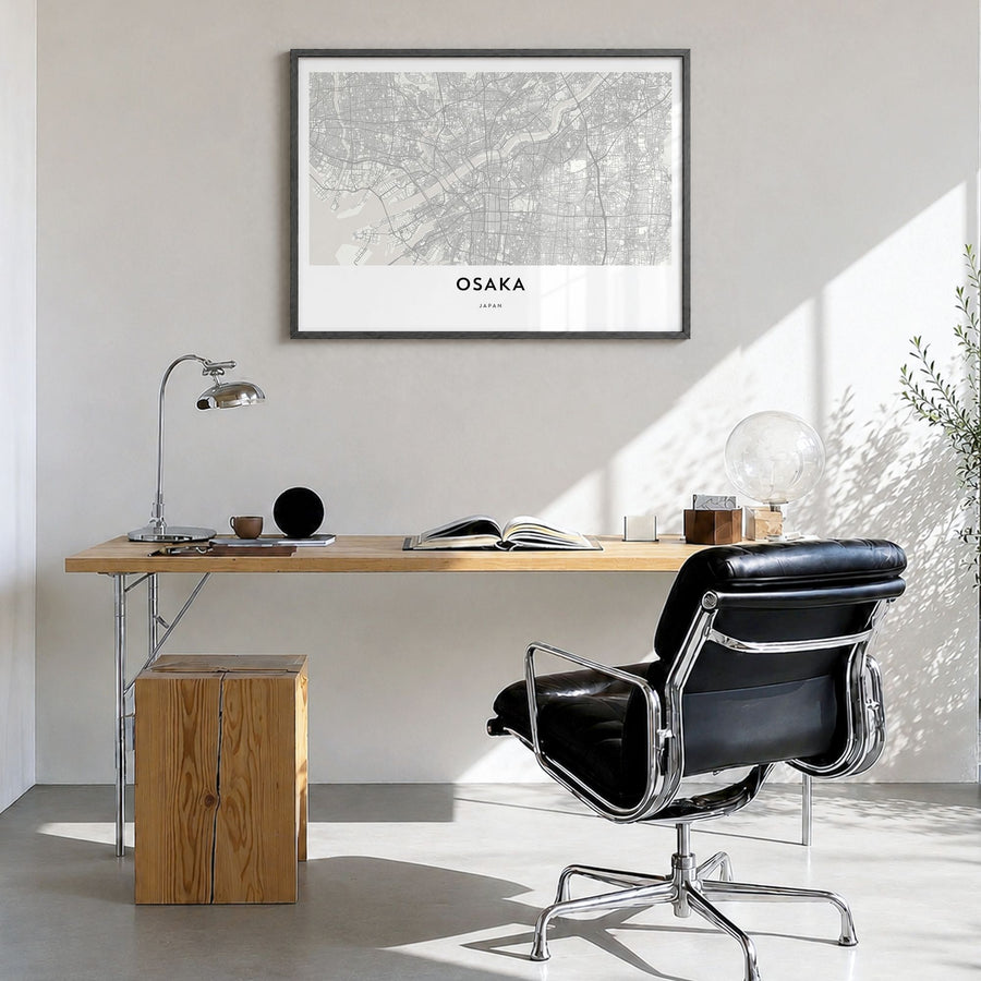 Osaka Map Poster in a black wood frame, hanging in a bright home office