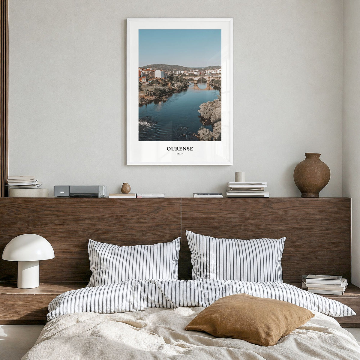 Ourense Classic Poster in a white wood frame, hanging in a bedroom