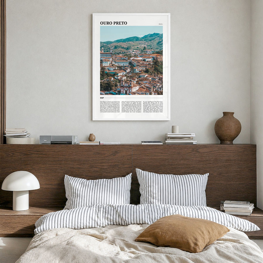 Ouro Preto Travel Poster in a white wood frame, hanging in a bedroom