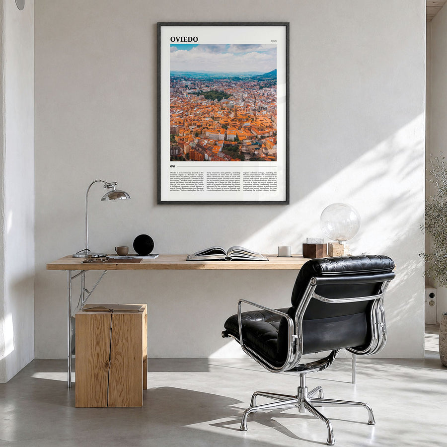 Oviedo Travel Poster in a black wood frame, hanging in a bright home office