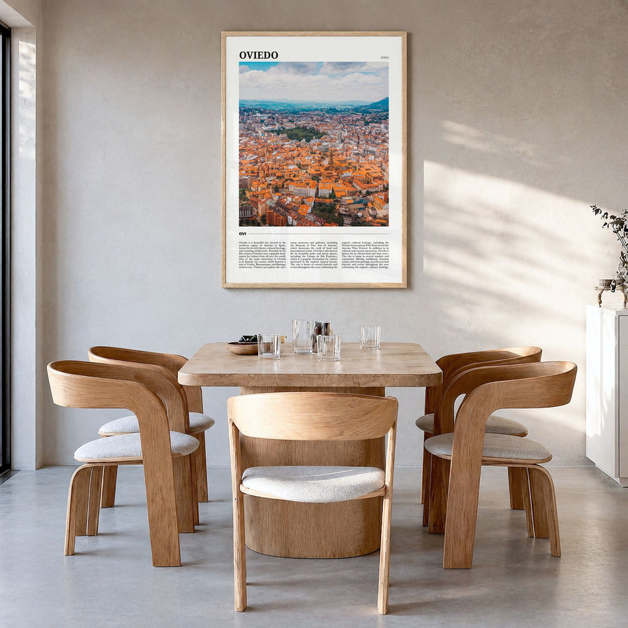 Oviedo Travel Poster in a natural wood frame, hanging in a dining room