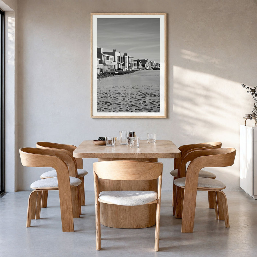 Oxnard Photo Poster in a natural wood frame, hanging in a dining room, white border