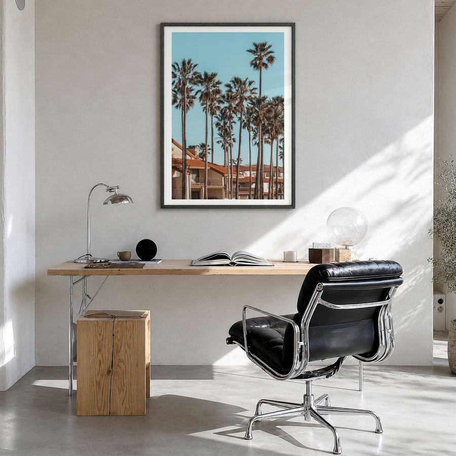Oxnard Photo Poster in a black wood frame, hanging in a bright home office, white border