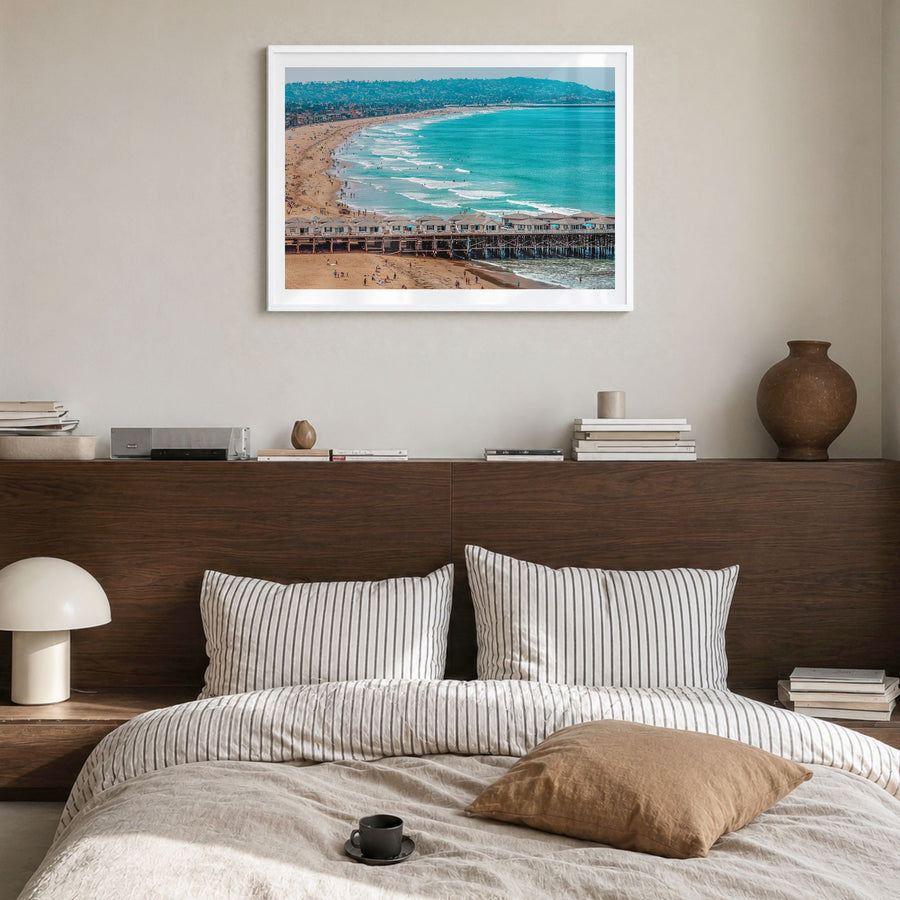 Pacific Beach Photo Poster in a white wood frame, hanging in a bedroom, white border
