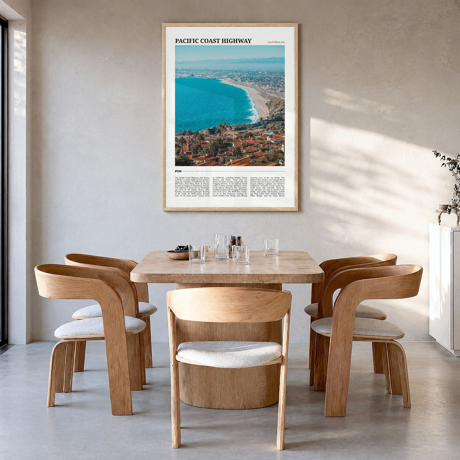 Pacific Coast Highway Travel Poster in a natural wood frame, hanging in a dining room