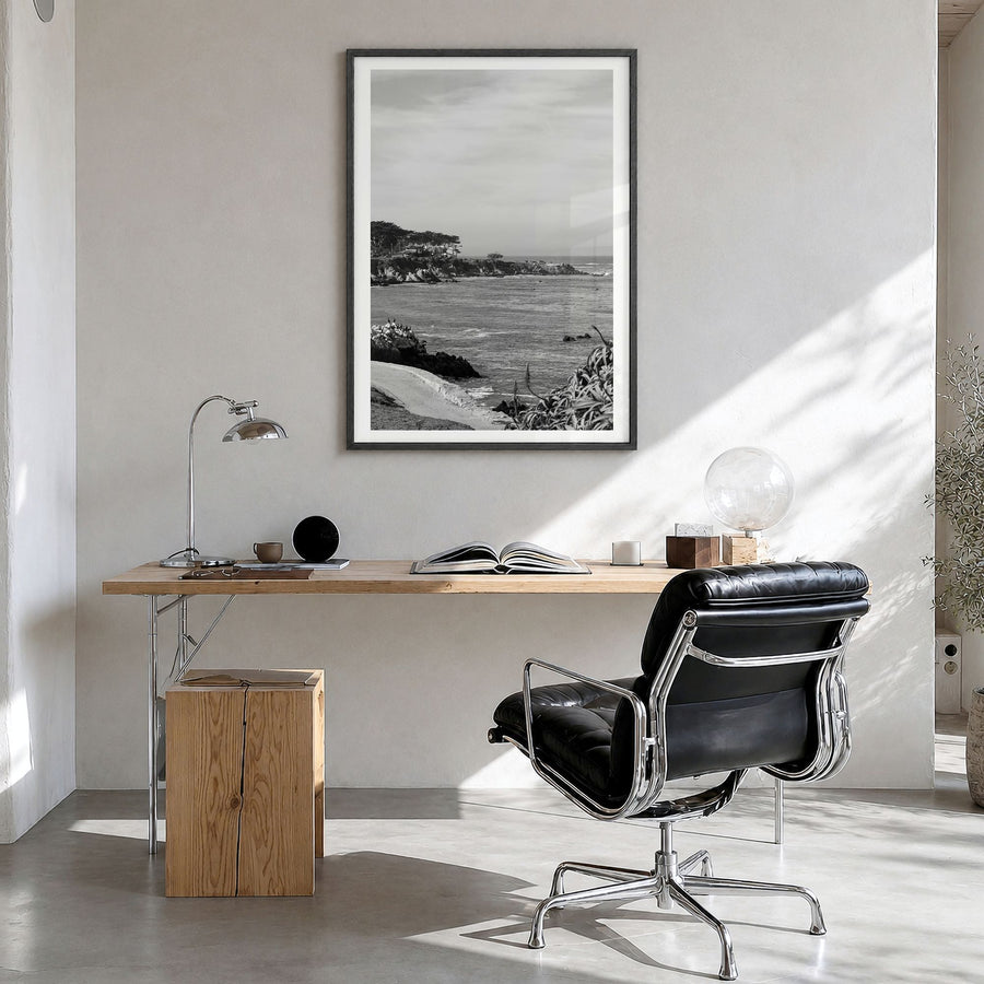 Pacific Grove Photo Poster in a black wood frame, hanging in a bright home office, white border