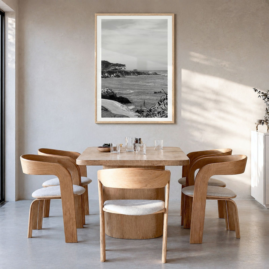 Pacific Grove Photo Poster in a natural wood frame, hanging in a dining room, white border