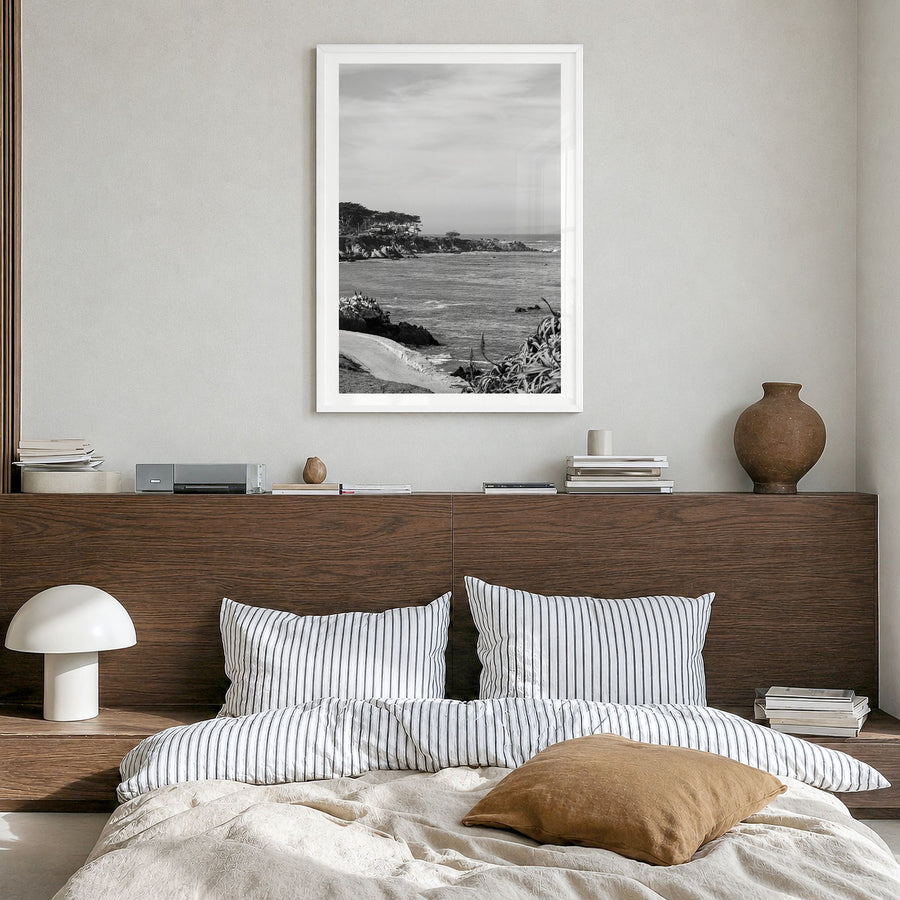 Pacific Grove Photo Poster in a white wood frame, hanging in a bedroom, white border