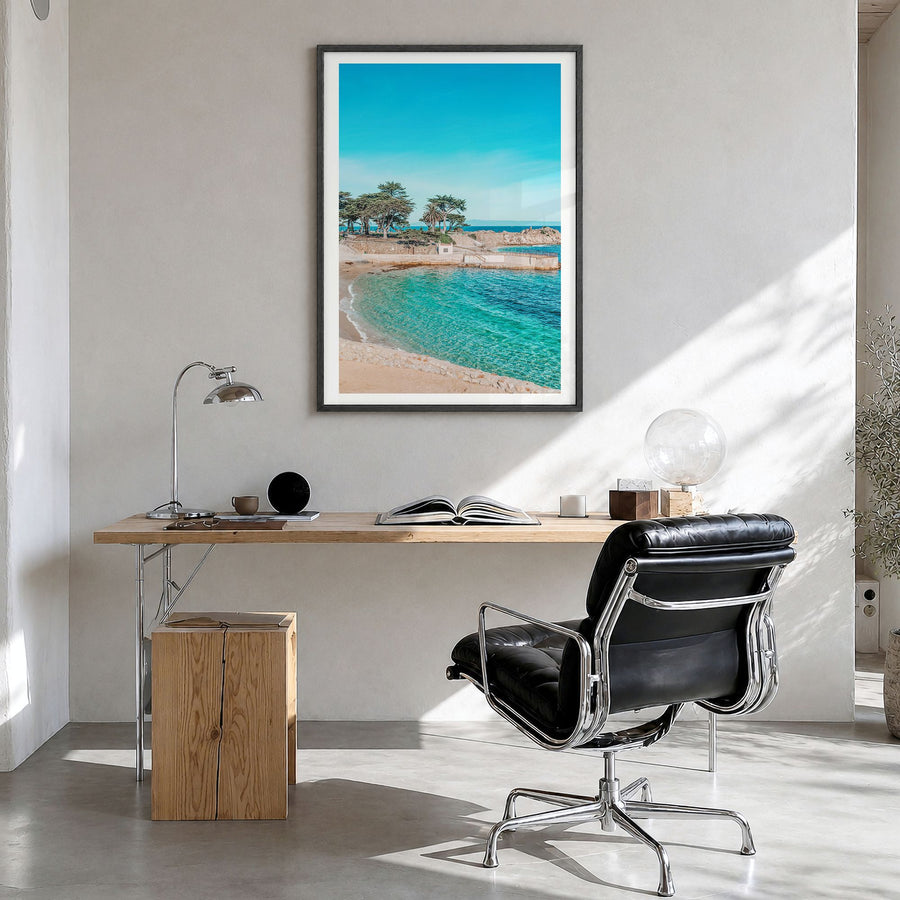 Pacific Grove Photo Poster in a black wood frame, hanging in a bright home office, white border