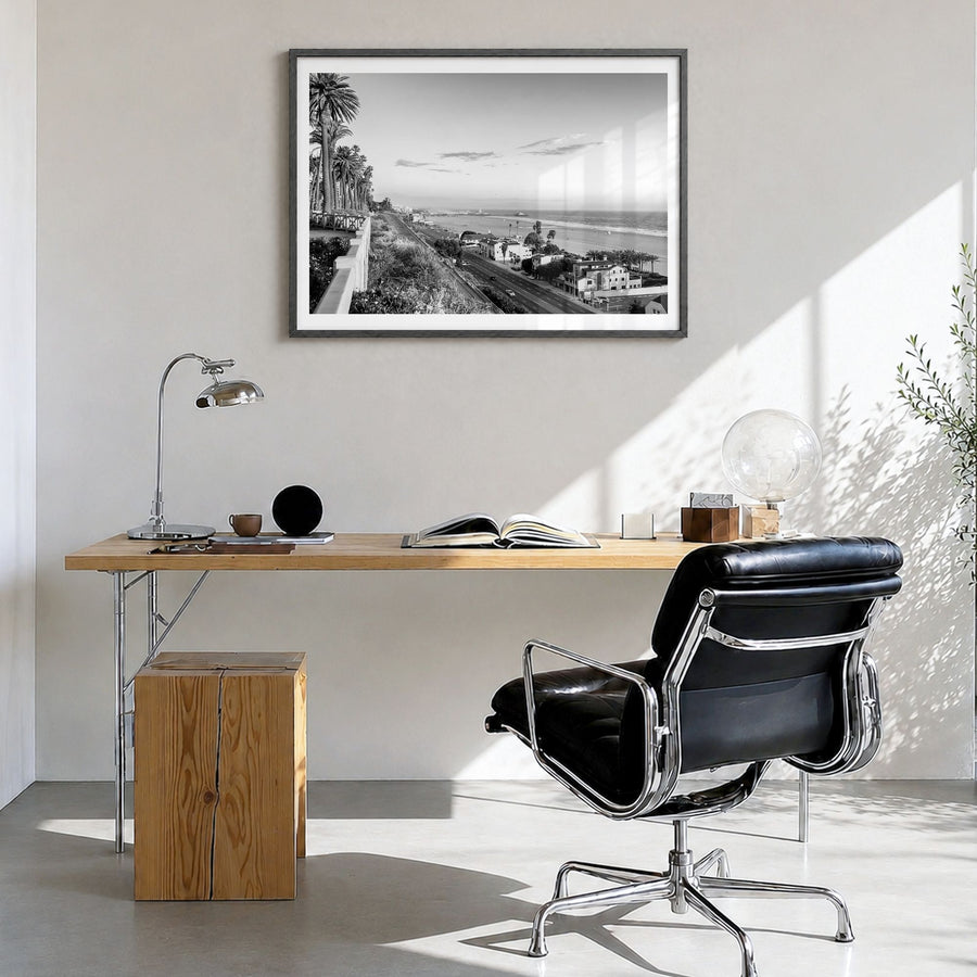 Pacific Palisades Photo Poster in a black wood frame, hanging in a bright home office, white border
