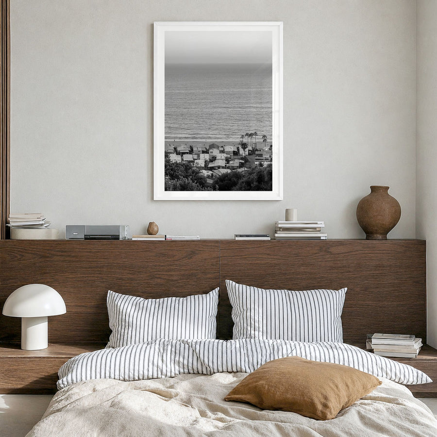 Pacific Palisades Photo Poster in a white wood frame, hanging in a bedroom, white border