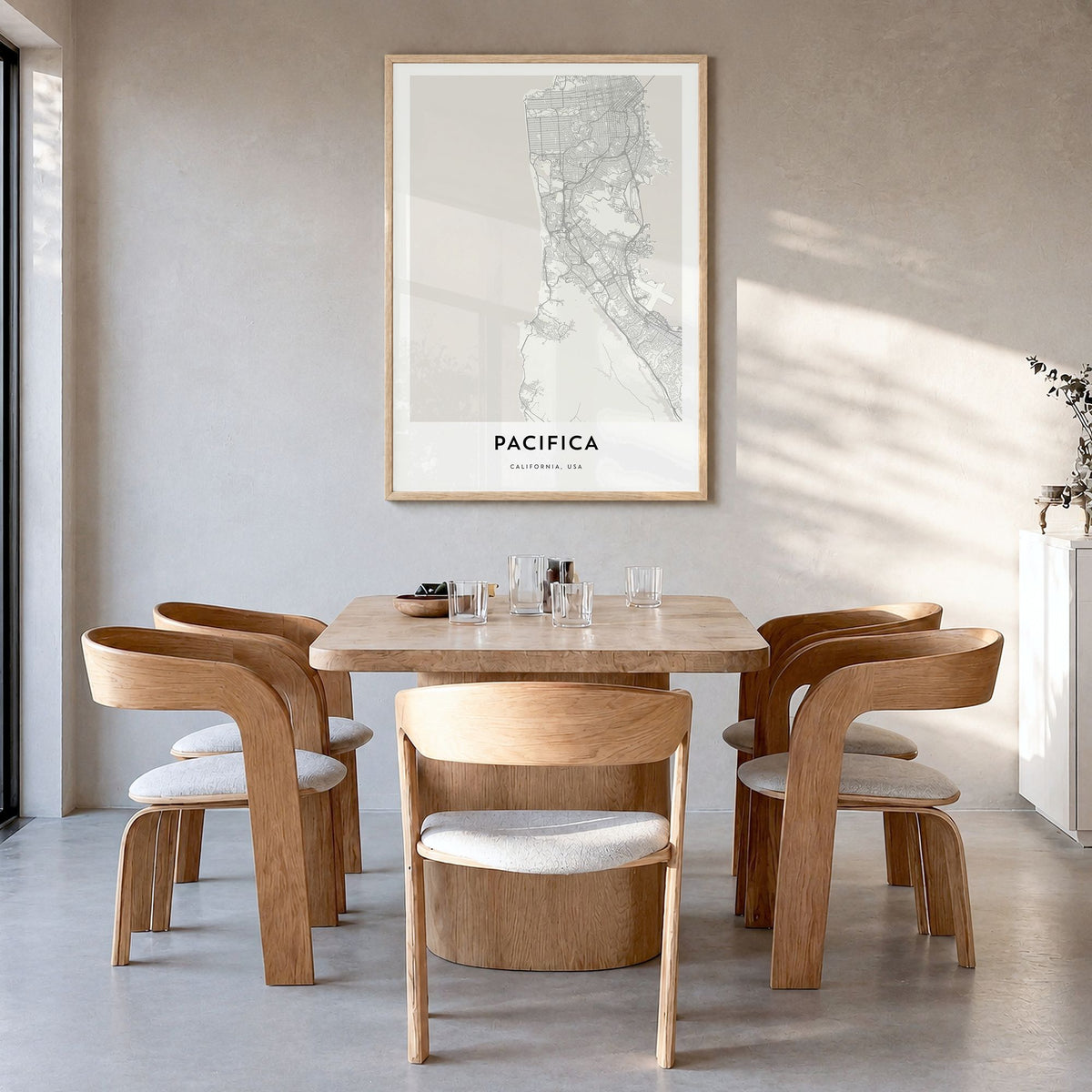 Pacifica Map Poster in a natural wood frame, hanging in a dining room