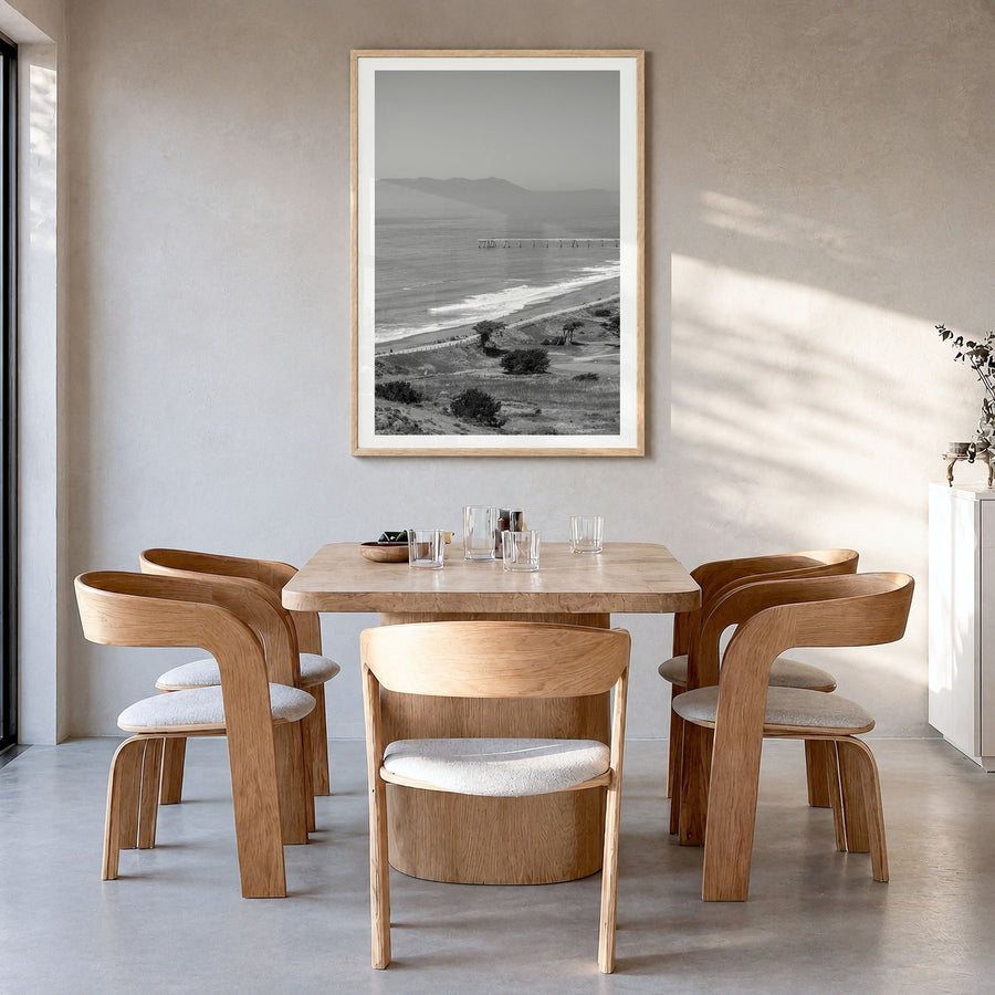 Pacifica Photo Poster in a natural wood frame, hanging in a dining room, white border