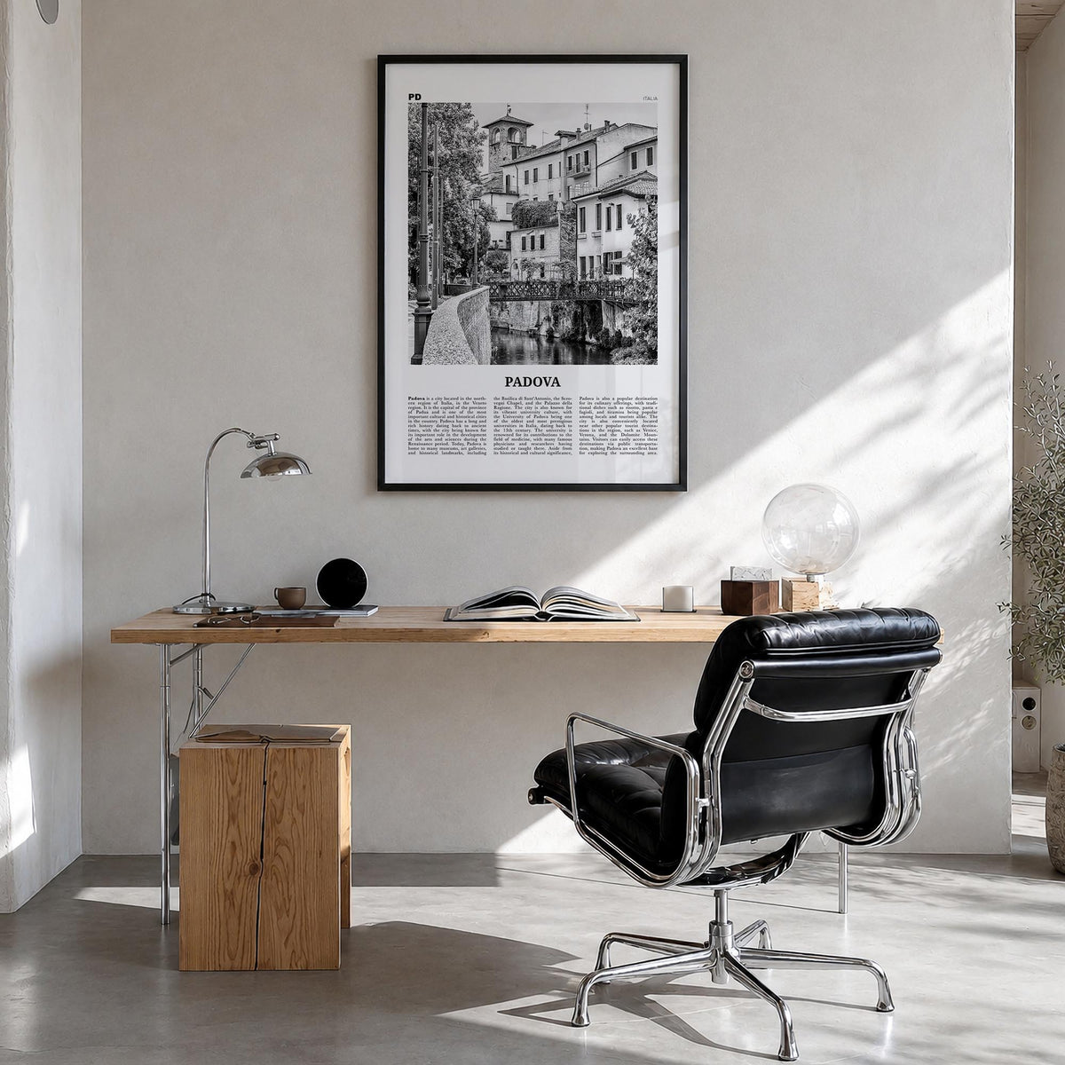 Padua no. 1 black & white newspaper poster of Padova, Italy – vertical wall art in black wood frame, hanging on wall