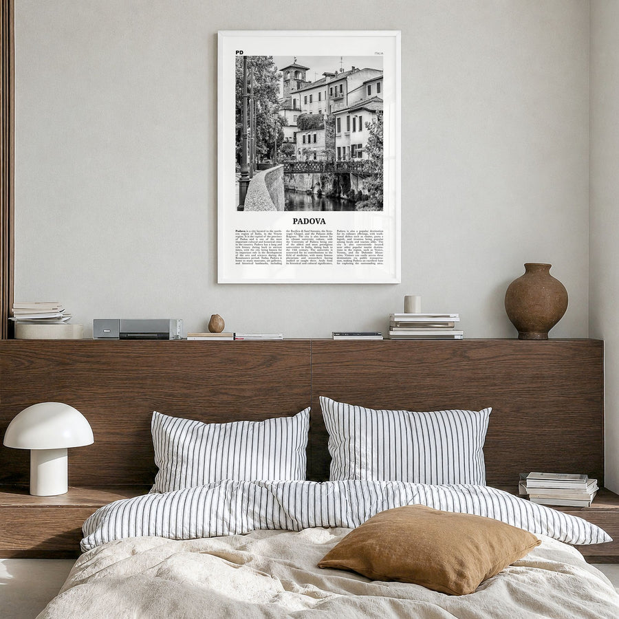 Padova Newspaper Poster in a white wood frame, hanging in a bedroom