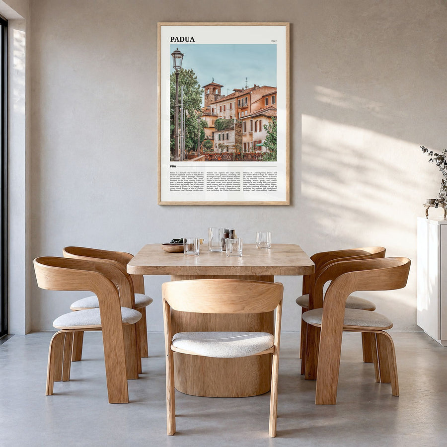 Padua Travel Poster in a natural wood frame, hanging in a dining room
