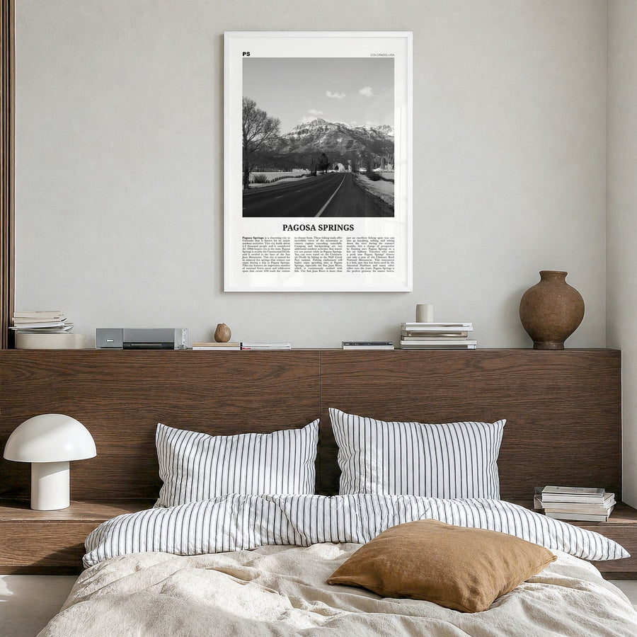 Pagosa Springs Newspaper Poster in a white wood frame, hanging in a bedroom
