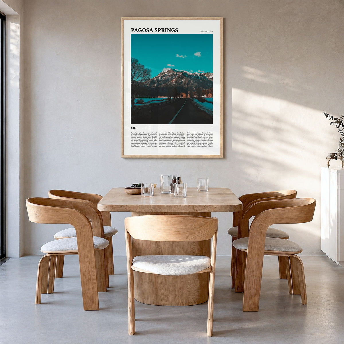 Pagosa Springs Travel Poster in a natural wood frame, hanging in a dining room