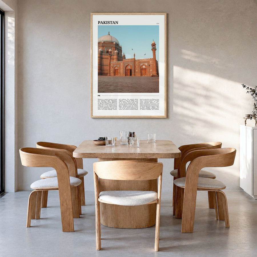 Pakistan Travel Poster in a natural wood frame, hanging in a dining room
