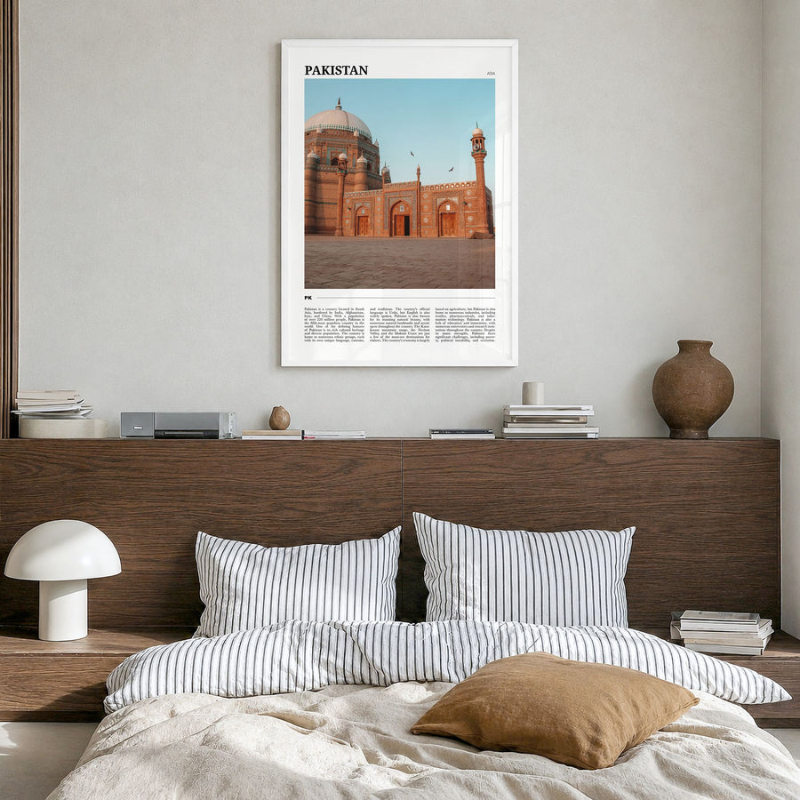 Pakistan Travel Poster in a white wood frame, hanging in a bedroom