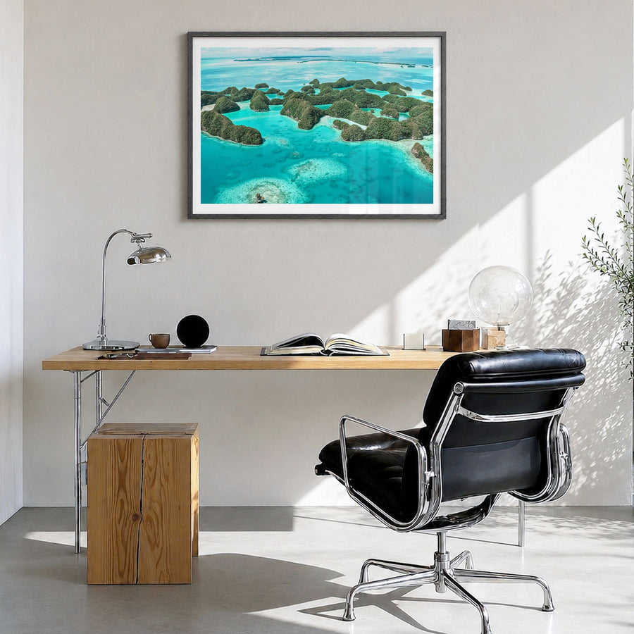Palau Photo Poster in a black wood frame, hanging in a bright home office, white border