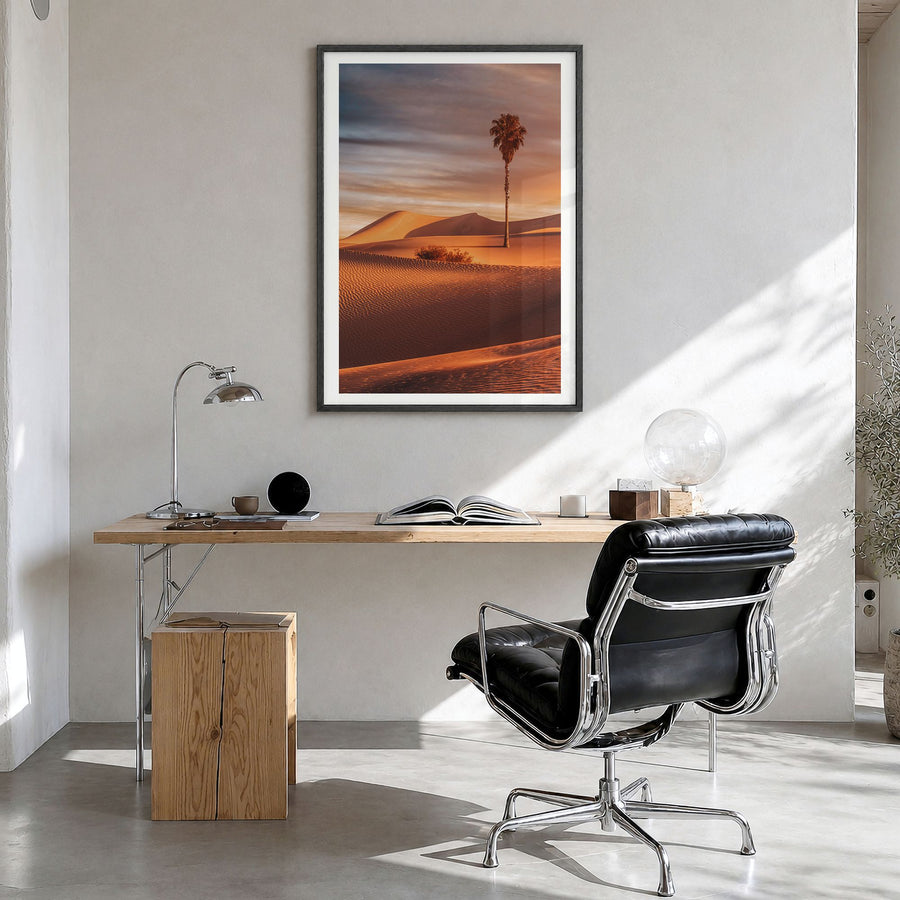 Palm Desert Photo Poster in a black wood frame, hanging in a bright home office, white border