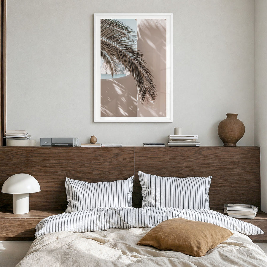 Palm Leaf Shadow Photo Poster in a white wood frame, hanging in a bedroom, white border